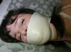 Microfoam ball-gagged lady fights in..